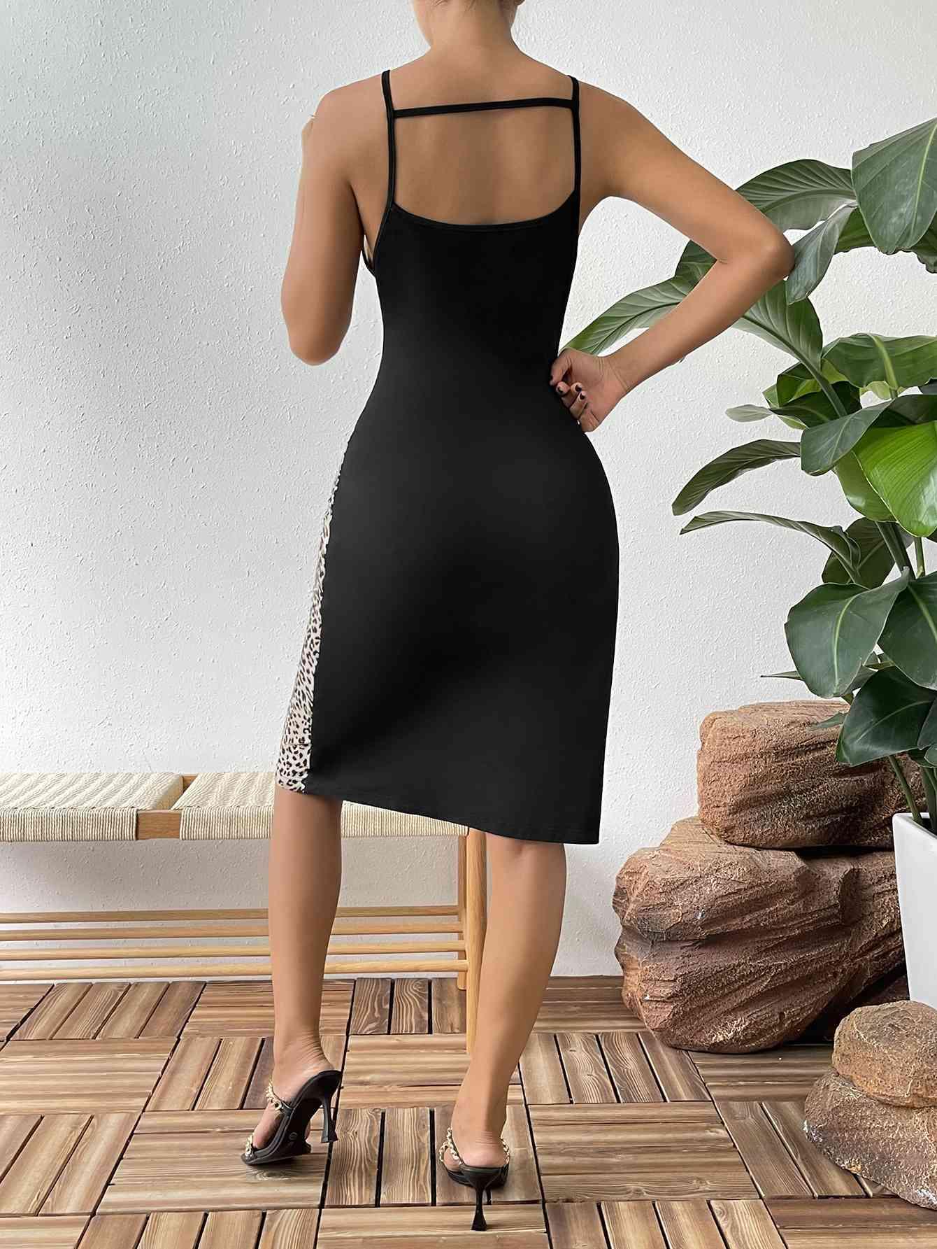 a woman in a black dress standing on a wooden floor