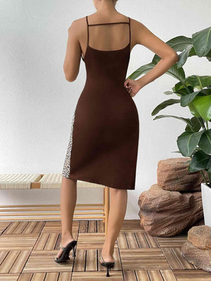 a woman in a brown dress is talking on a cell phone