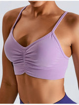 a woman wearing a purple sports bra top