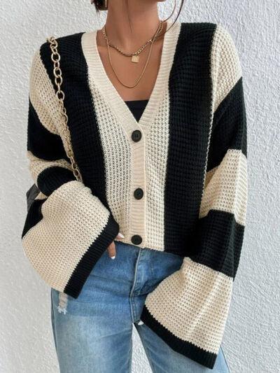 a woman wearing a black and white striped cardigan sweater