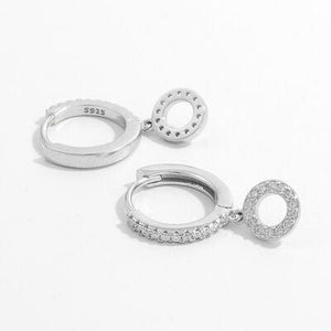 a pair of silver hoop earrings on a white background