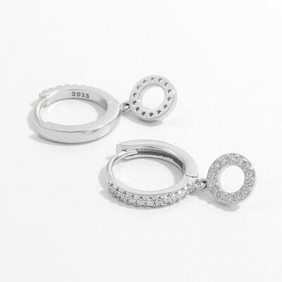 a pair of silver hoop earrings on a white background