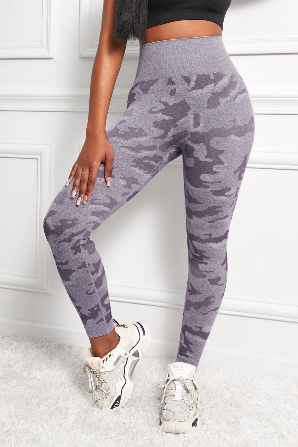 a woman in a black top and grey camouflage print leggings