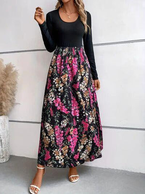 a woman wearing a black top and floral print skirt