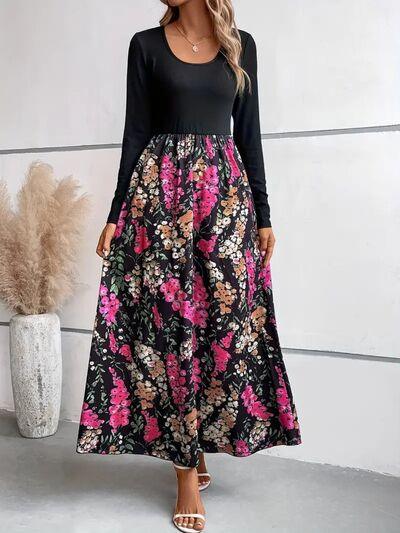 a woman wearing a black and pink floral print dress