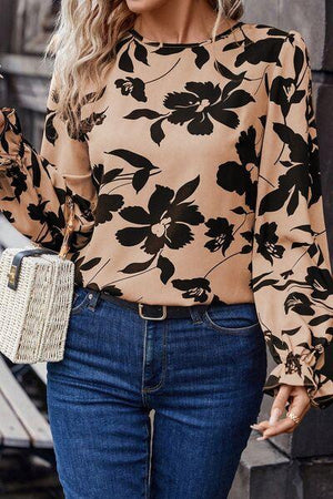 a woman wearing a floral blouse and jeans