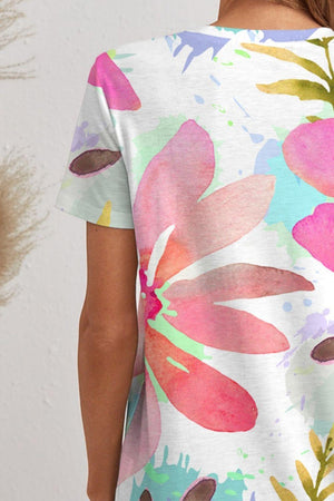 a woman wearing a white shirt with colorful flowers on it