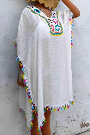 a woman wearing a white poncho and a straw hat