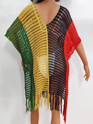 a doll is wearing a colorful knitted ponchy
