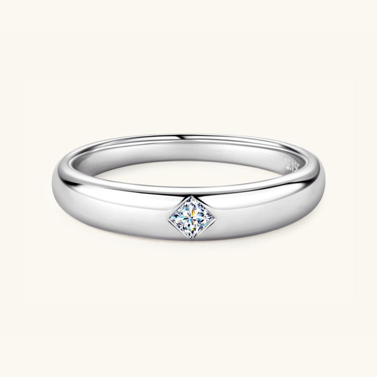 a white gold ring with a princess cut diamond