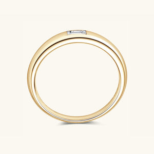 a yellow gold wedding ring with a diamond set in the center