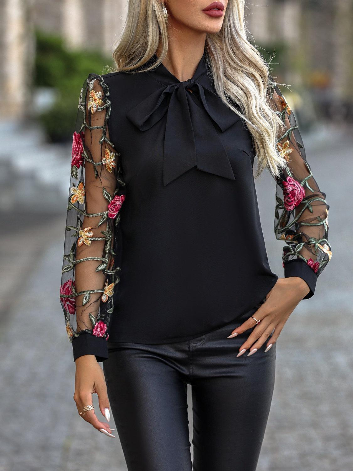 a woman wearing black leather pants and a black blouse