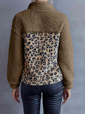 a woman wearing a jacket with a leopard print on it