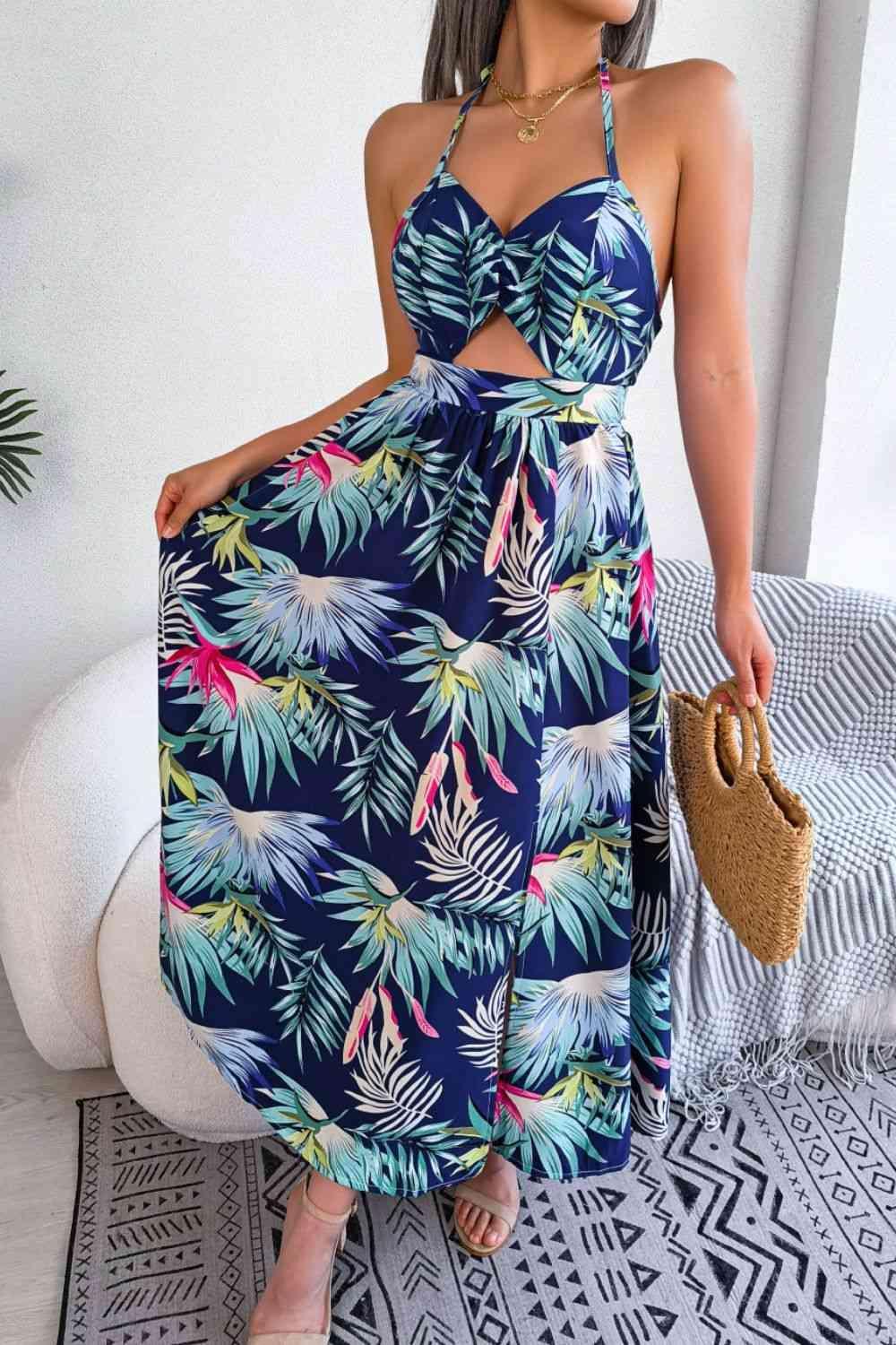 a woman wearing a blue tropical print dress