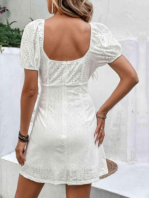 a woman wearing a white dress with a back cut out