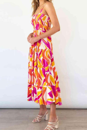 a woman in a colorful dress posing for a picture