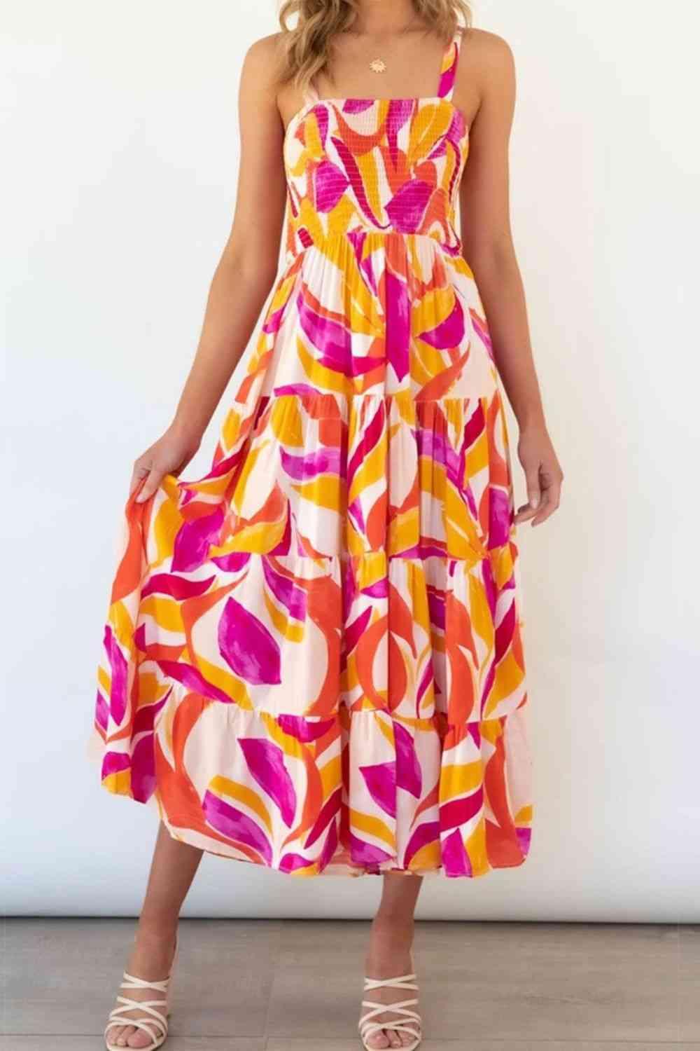 a woman in a colorful dress standing in front of a white wall