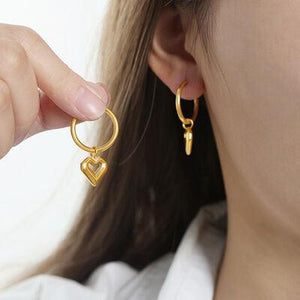 a close up of a person wearing a pair of earrings