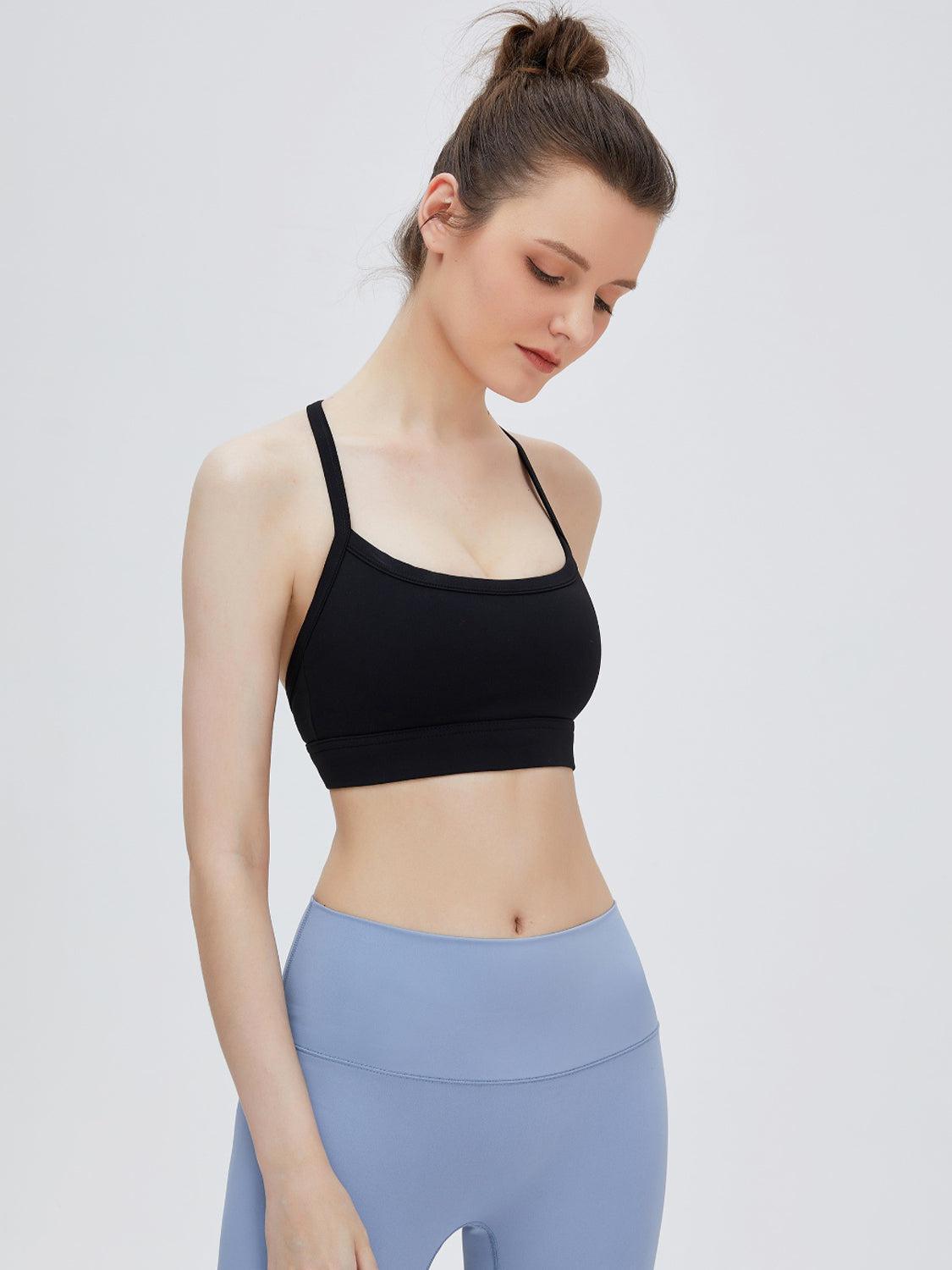 a woman in a black sports bra top and blue leggings