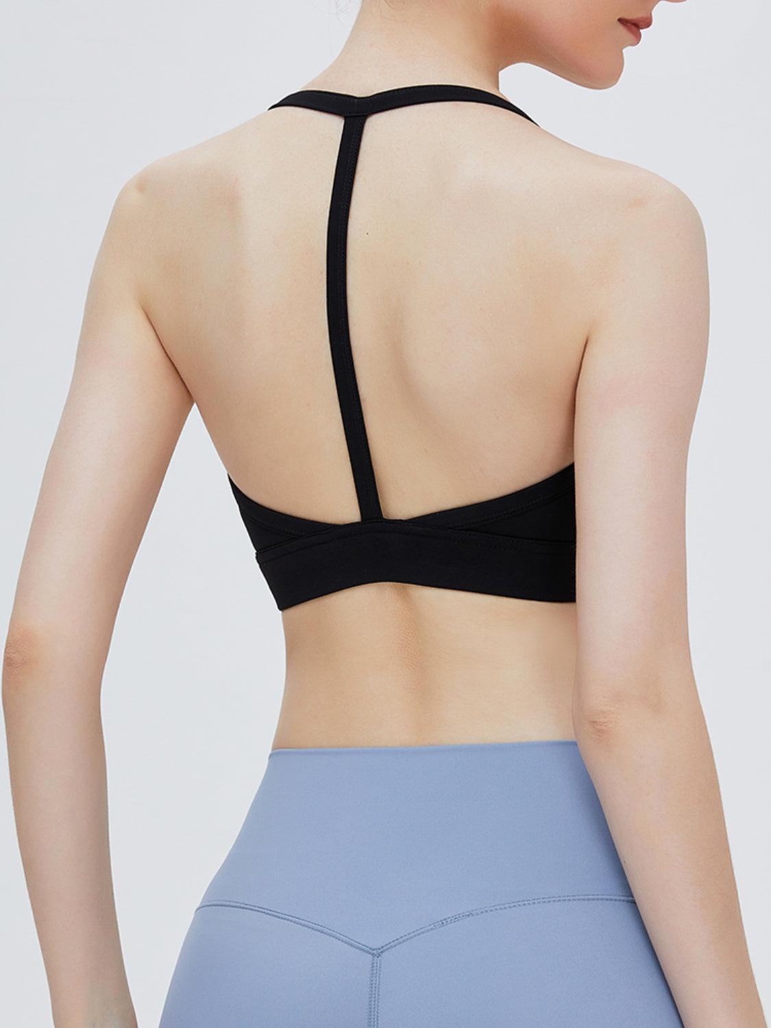 the back of a woman wearing a black sports bra