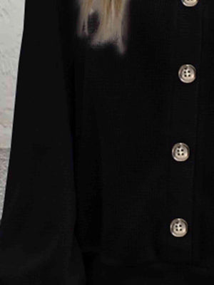 a woman with long blonde hair wearing a black jacket