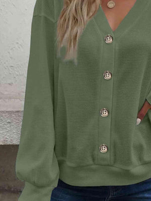 a woman wearing a green sweater and jeans