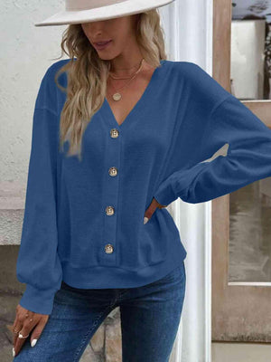 a woman wearing a blue blouse and jeans