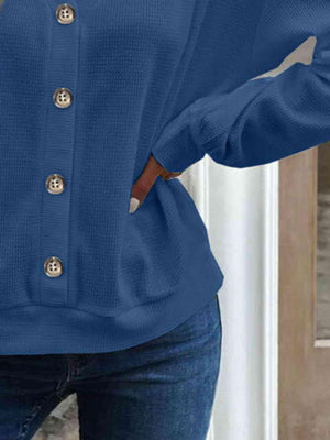 a woman wearing a blue sweater and jeans