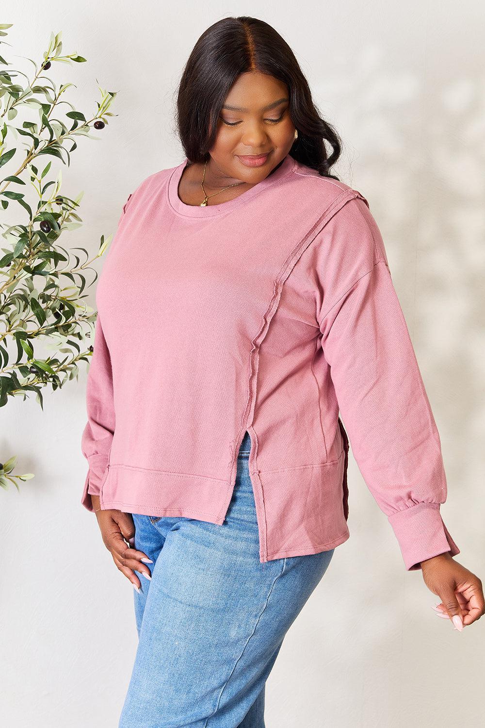 a woman in a pink top is posing for a picture