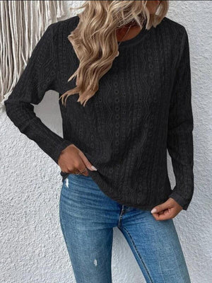 a woman wearing a black sweater and jeans