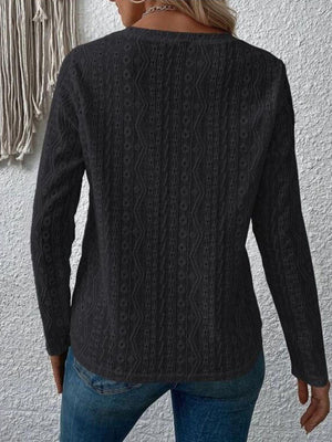 a woman wearing a black sweater and jeans