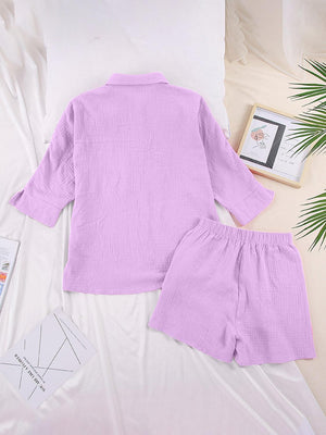 a pink shirt and shorts are on a bed