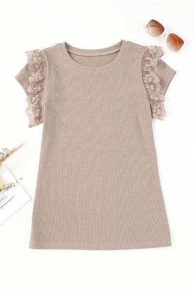 a little girl's dress with a flower on the shoulder