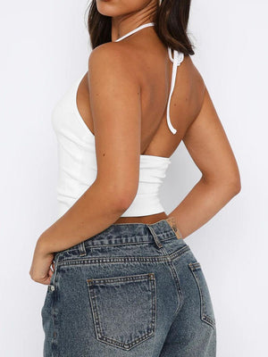 a woman wearing a white top and jeans