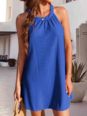 a woman wearing a blue dress and a straw hat