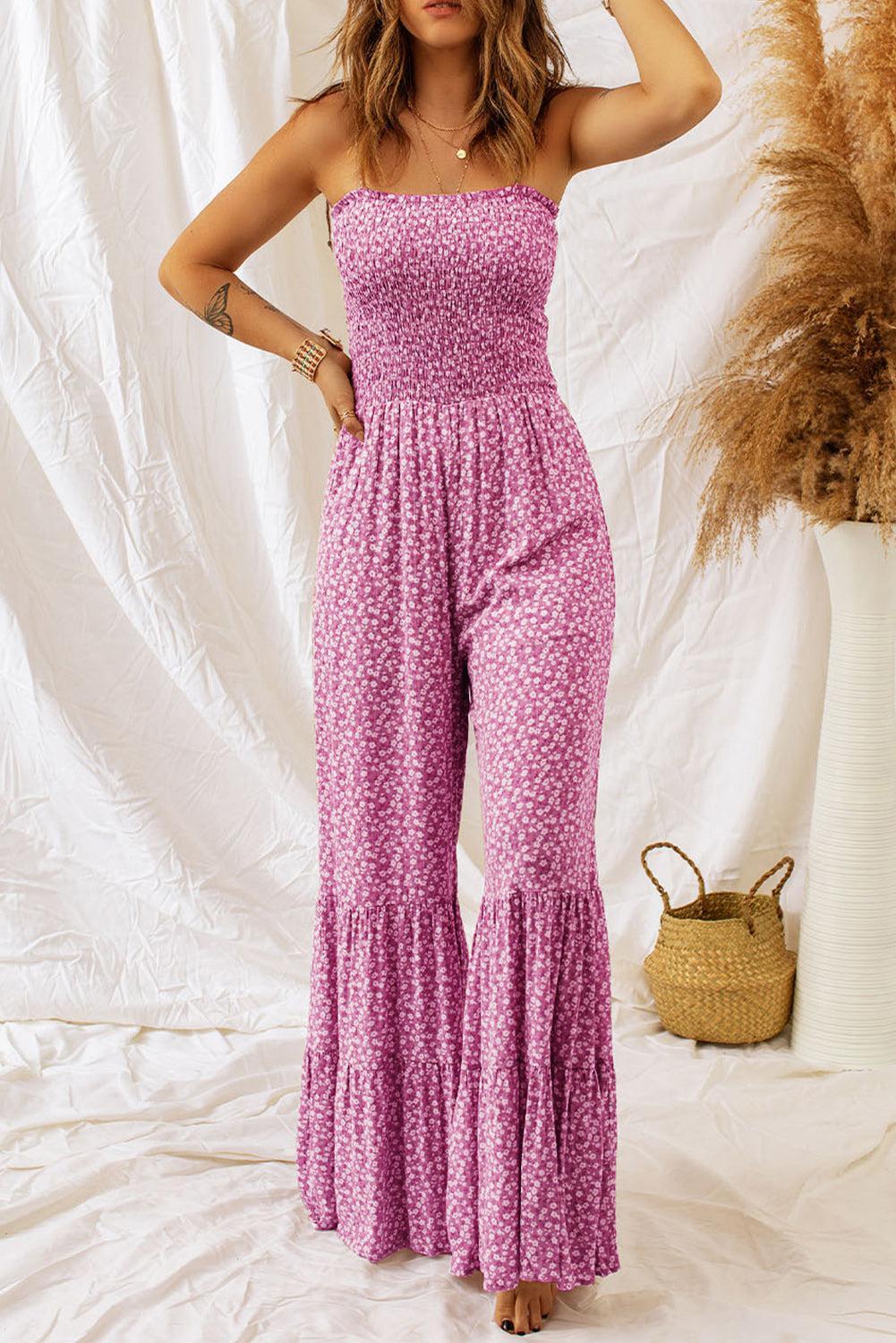 a woman in a pink jumpsuit posing for a picture