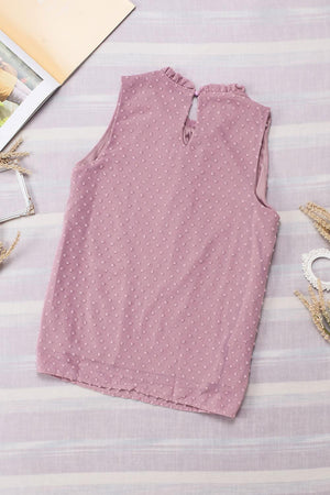 a pink top sitting on top of a table