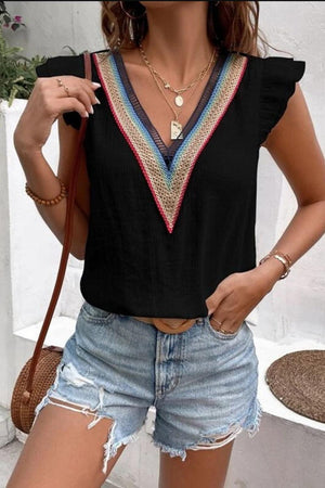 a woman wearing shorts and a black top