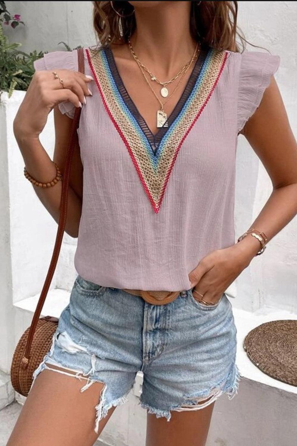 a woman in shorts and a top posing for a picture