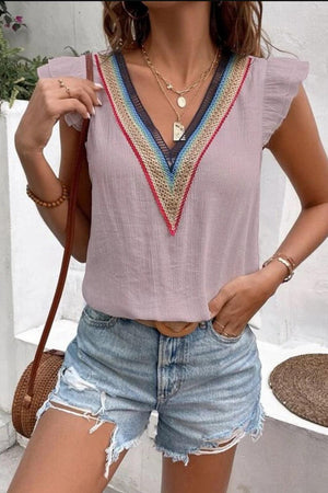 a woman in shorts and a top posing for a picture