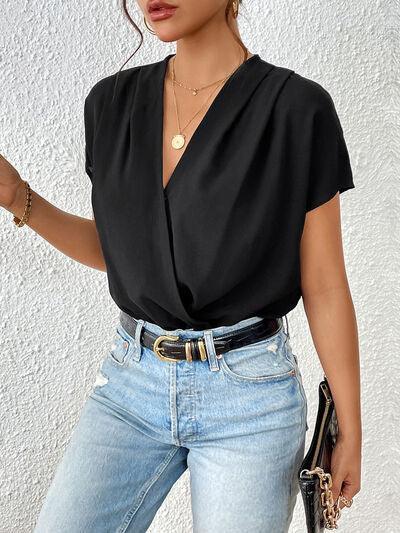 a woman wearing a black shirt and jeans