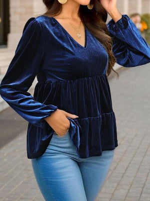 a woman wearing a blue top and jeans