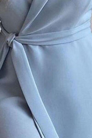 a close up of a woman wearing a blue dress