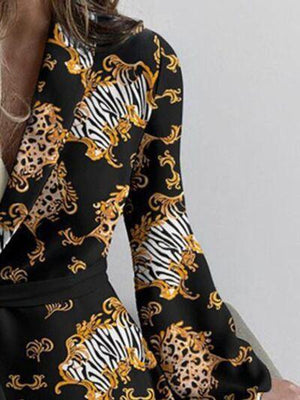 a woman wearing a black and gold dress