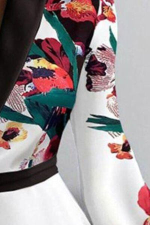 a close up of a person wearing a dress with flowers on it