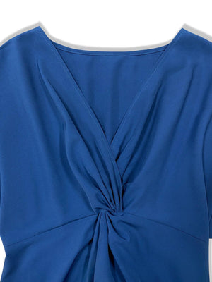a blue top with a knot on the front