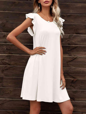 a woman in a white dress posing for the camera