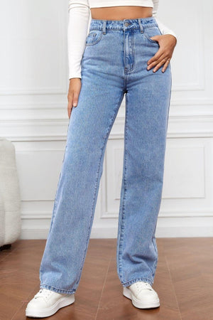 a woman in a white crop top and jeans