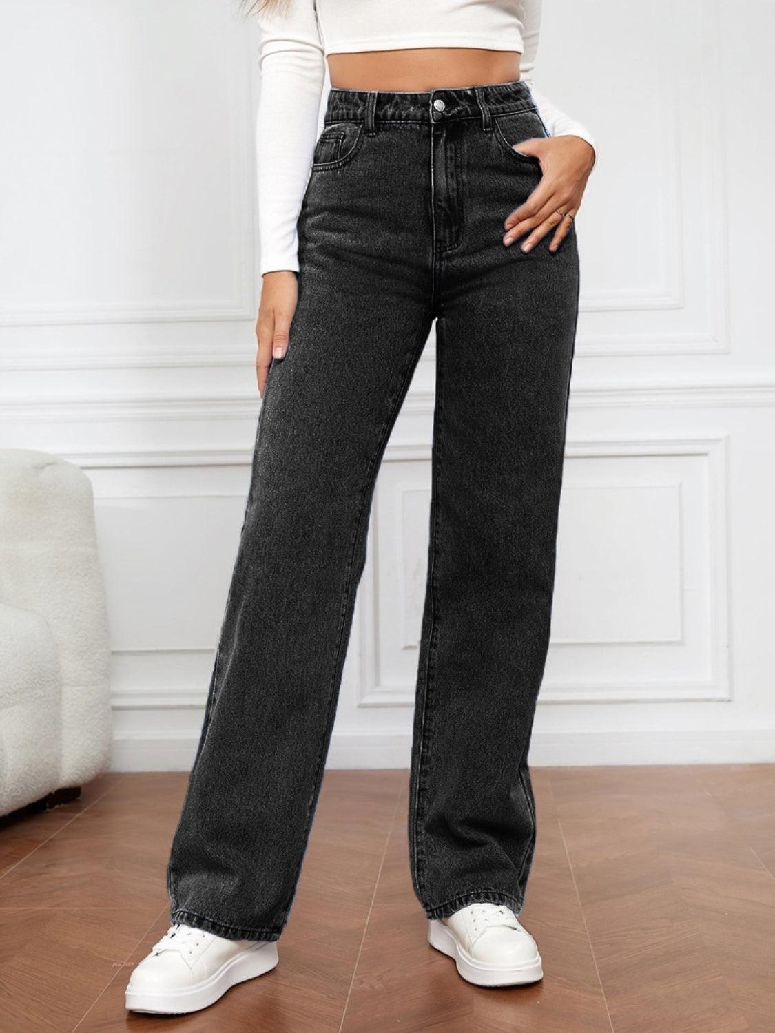 a woman in a white top and black jeans