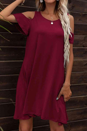 a woman wearing a red dress and a hat